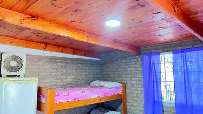 a bunk bed in a room with a wooden ceiling at Monoambiente a metros del río in Tanti