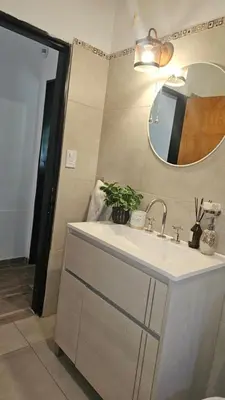 a bathroom with a sink and a mirror at Chalet alaniz salinas in Cordoba