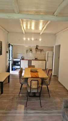 a kitchen and dining room with a table and chairs at Chalet alaniz salinas in Cordoba