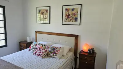 a bedroom with a bed with pillows on it at Chalet alaniz salinas in Cordoba
