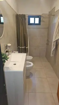 a bathroom with a sink and a toilet and a shower at Chalet alaniz salinas in Cordoba