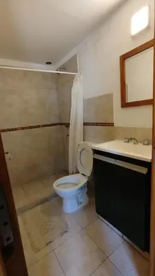 a bathroom with a toilet and a sink at Departamento Don Pipo in Villa Carlos Paz
