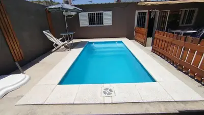 a swimming pool in the backyard of a house at Departamento Don Pipo in Villa Carlos Paz
