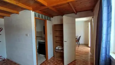a room with white walls and a wooden ceiling at Departamento Don Pipo in Villa Carlos Paz