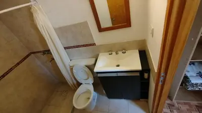 a small bathroom with a toilet and a sink at Departamento Don Pipo in Villa Carlos Paz