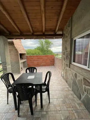 a black table and chairs on a patio at Faroflor departamento in Arroyo de Los Patos