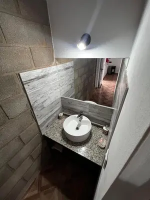 a bathroom with a sink and a counter at Faroflor departamento in Arroyo de Los Patos