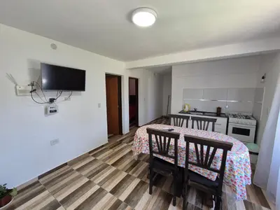 a room with a table and two chairs and a kitchen at Cabañas Colibri in Merlo