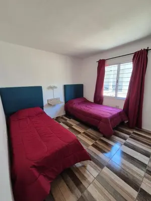 a bedroom with two beds and a window at Cabañas Colibri in Merlo