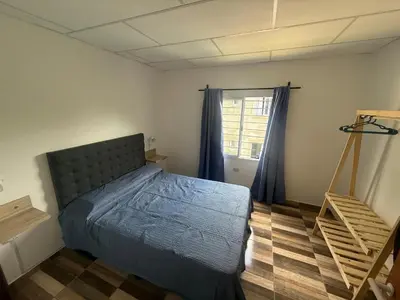 a bedroom with a bed and a window at Cabañas Colibri in Merlo