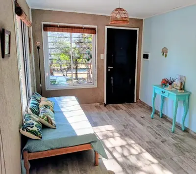 a room with a bed and a table and a window at La Berilde in La Población