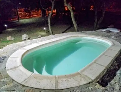 a large swimming pool in a yard at night at La Berilde in La Población