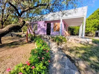 a purple house with flowers in front of it at La Berilde in La Población