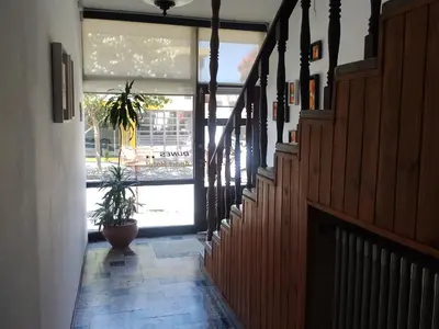 a hallway with a potted plant in front of a window at Hotel Dunes in Villa Carlos Paz