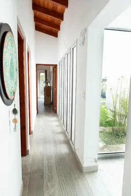 a hallway of a house with white walls and wood floors at Señal de Amor in Villa General Belgrano