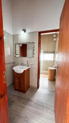 a bathroom with a sink and a mirror and a tub at Señal de Amor in Villa General Belgrano