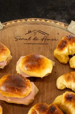 a wooden cutting board with pastries on a cutting board at Señal de Amor in Villa General Belgrano