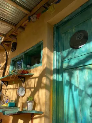 a door to a house with a green curtain at Cosmika, eco casa de Cosmika, eco casa de montaña in Las Calles