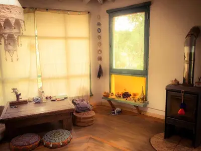 a room with a wooden table and a window at Cosmika, eco casa de Cosmika, eco casa de montaña in Las Calles