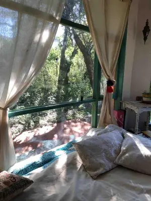 a bedroom with a bed and a window with a view at Cosmika, eco casa de Cosmika, eco casa de montaña in Las Calles