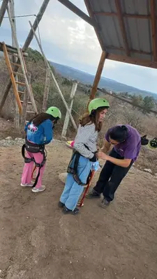 a woman and two children with helmets on top of a hill at Complejo Gran Chacha in Tanti