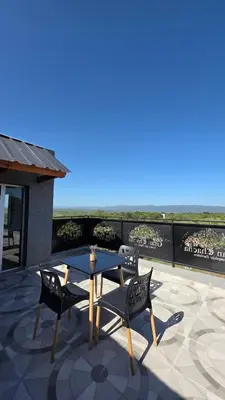 a patio with a table and two chairs on a roof at Complejo Gran Chacha in Tanti