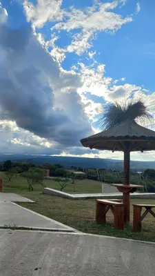 a picnic table and an umbrella on the side of a road at Complejo Gran Chacha in Tanti