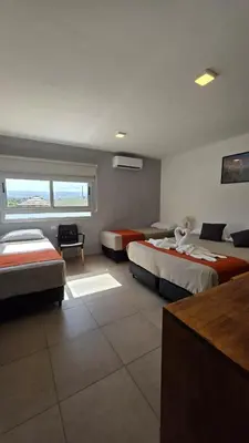 a hotel room with two beds and a window at Complejo Gran Chacha in Tanti