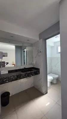 a bathroom with a sink and a toilet and a mirror at Complejo Gran Chacha in Tanti