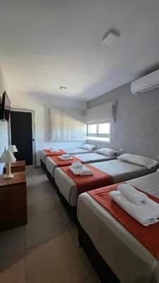 a row of beds in a hotel room at Complejo Gran Chacha in Tanti