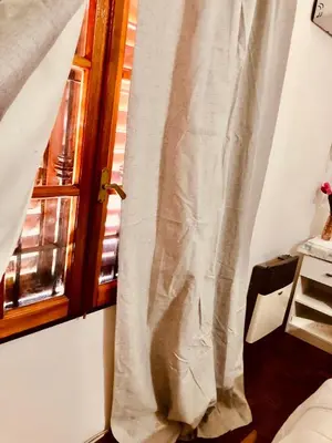 a curtain is hanging next to a window at Habitación exclusiva Huéspedes con piscina , aire acondicionado y jardín en base doble, muy confortable in Cordoba