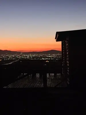 a view of a city at sunset from a building at Aruma Cabañas in Tanti