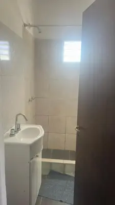 a bathroom with a sink and a shower at Mi casa in Villa Carlos Paz