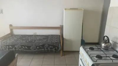 a small kitchen with a bed and a stove at Mi casa in Villa Carlos Paz