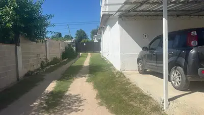 a car parked in a garage next to a wall at Mi casa in Villa Carlos Paz