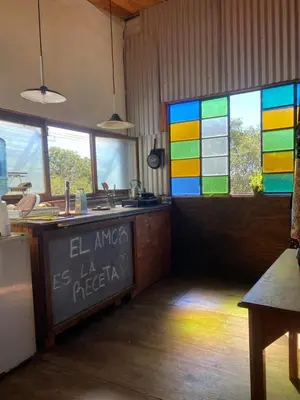 a kitchen with a rainbow stained glass window at Eco Refugio de Montaña en San Javier, Traslasierra in San Javier