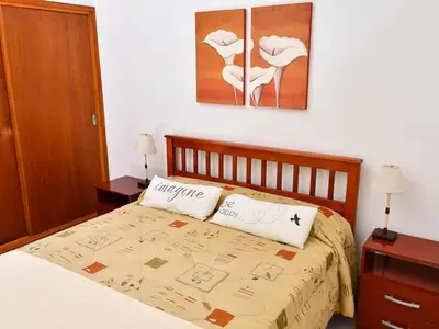 a bed with two pillows on it in a bedroom at Depto 1 in Villa Carlos Paz