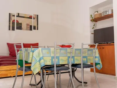 a dining room table and chairs in a room at Depto 1 in Villa Carlos Paz