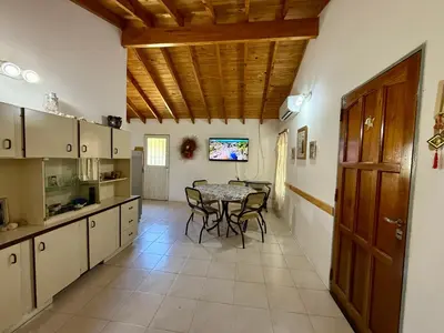 a kitchen and dining room with a table and chairs at Casa Los Prados Mina Clavero in Mina Clavero