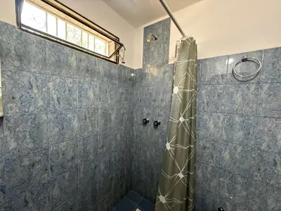a bathroom with a shower with a shower curtain at Casa Los Prados Mina Clavero in Mina Clavero