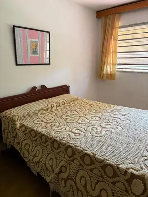 a bedroom with a bed in a room with a window at Casa centro in Villa Carlos Paz