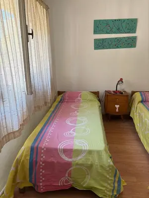 a bedroom with a bed with a colorful blanket at Casa centro in Villa Carlos Paz