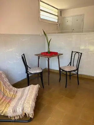 a table and two chairs and a table with a plant on it at Casa centro in Villa Carlos Paz