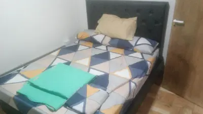 a small bed in a room with at Cabaña Aguaribay in Villa Anizacate