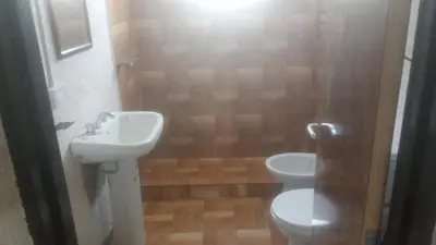 a bathroom with a sink and a toilet at Cabaña Aguaribay in Villa Anizacate