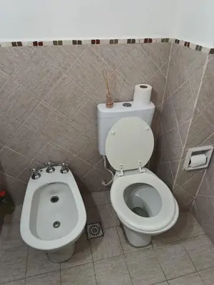 a bathroom with a toilet and a bidet at Microcentro La Cañada in Cordoba