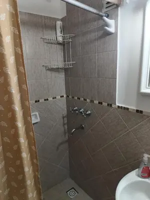 a bathroom with a shower with a sink and a toilet at Microcentro La Cañada in Cordoba