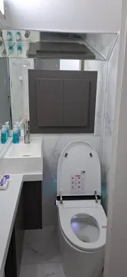 a white bathroom with a toilet and a sink at Alojamiento de lujo , duplex - departamento in Villa Carlos Paz