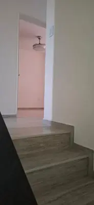 an empty room with stairs and a white wall at Alojamiento de lujo , duplex - departamento in Villa Carlos Paz