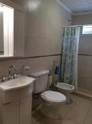 a bathroom with a toilet and a sink and a shower at mi casita en tanti, casa 25 in Tanti